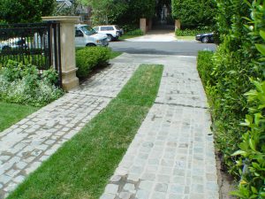 Ribbon driveway with antique reclaimed cobblestone